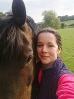 Emma Slawinski, our European Programmes Director, standing with a horse - blogger profile